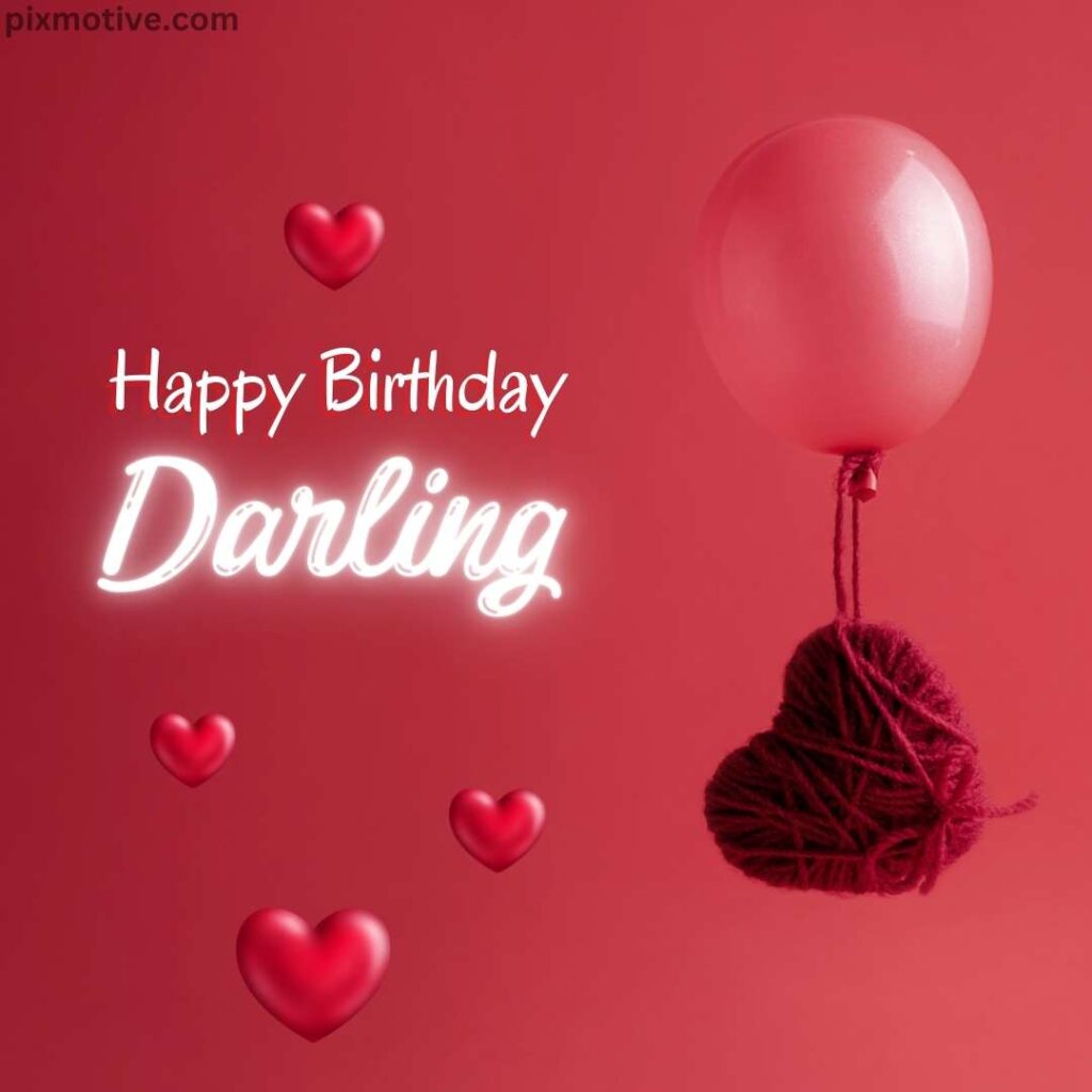 Happy birthday darling with a red balloon and heart made of thread